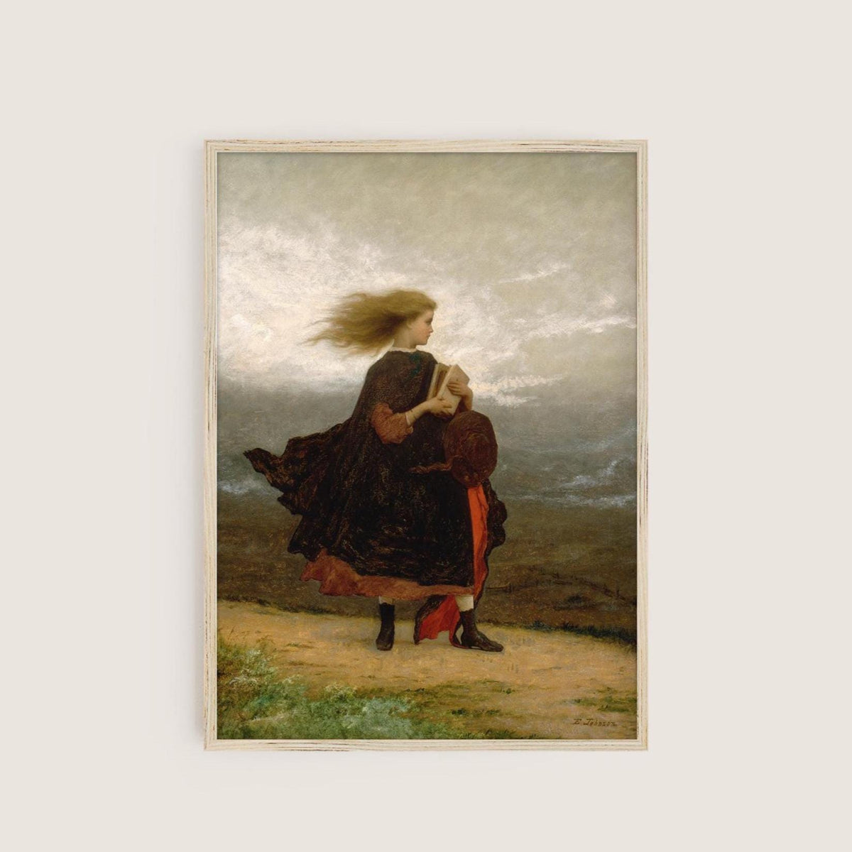A fine art print hangs on a neutral wall in a simple wooden picture frame. The picture depicts a windswept young lady walking across a landscape in a velvet coat and holding a book.