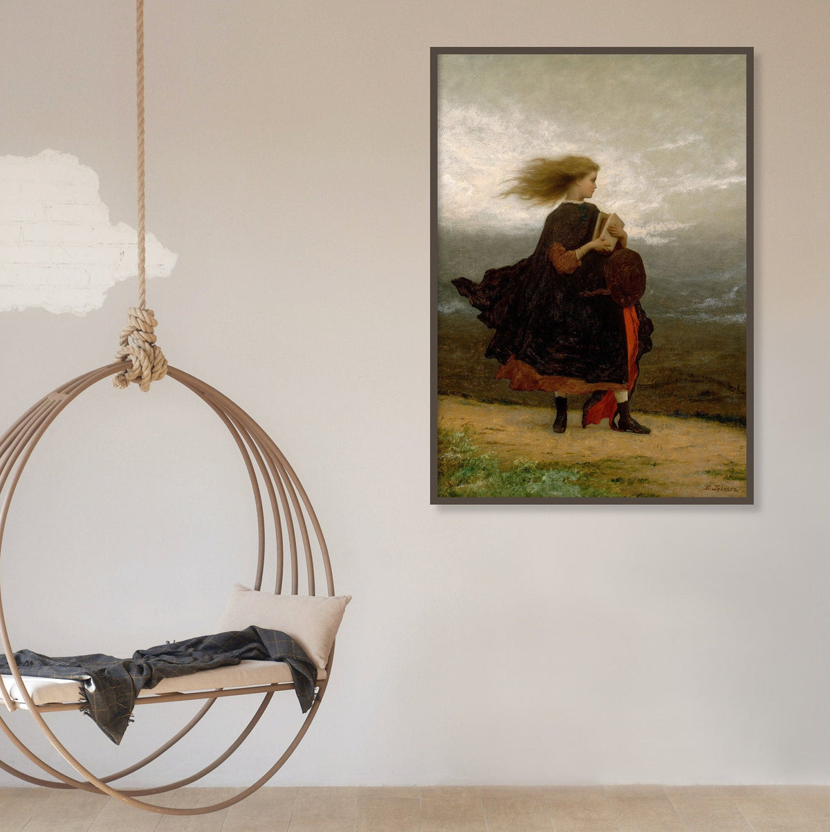 A fine art print hangs on a wall with a large round swing hanging from the ceiling. The picture depicts a windswept young lady walking across a landscape in a velvet coat and holding a book.