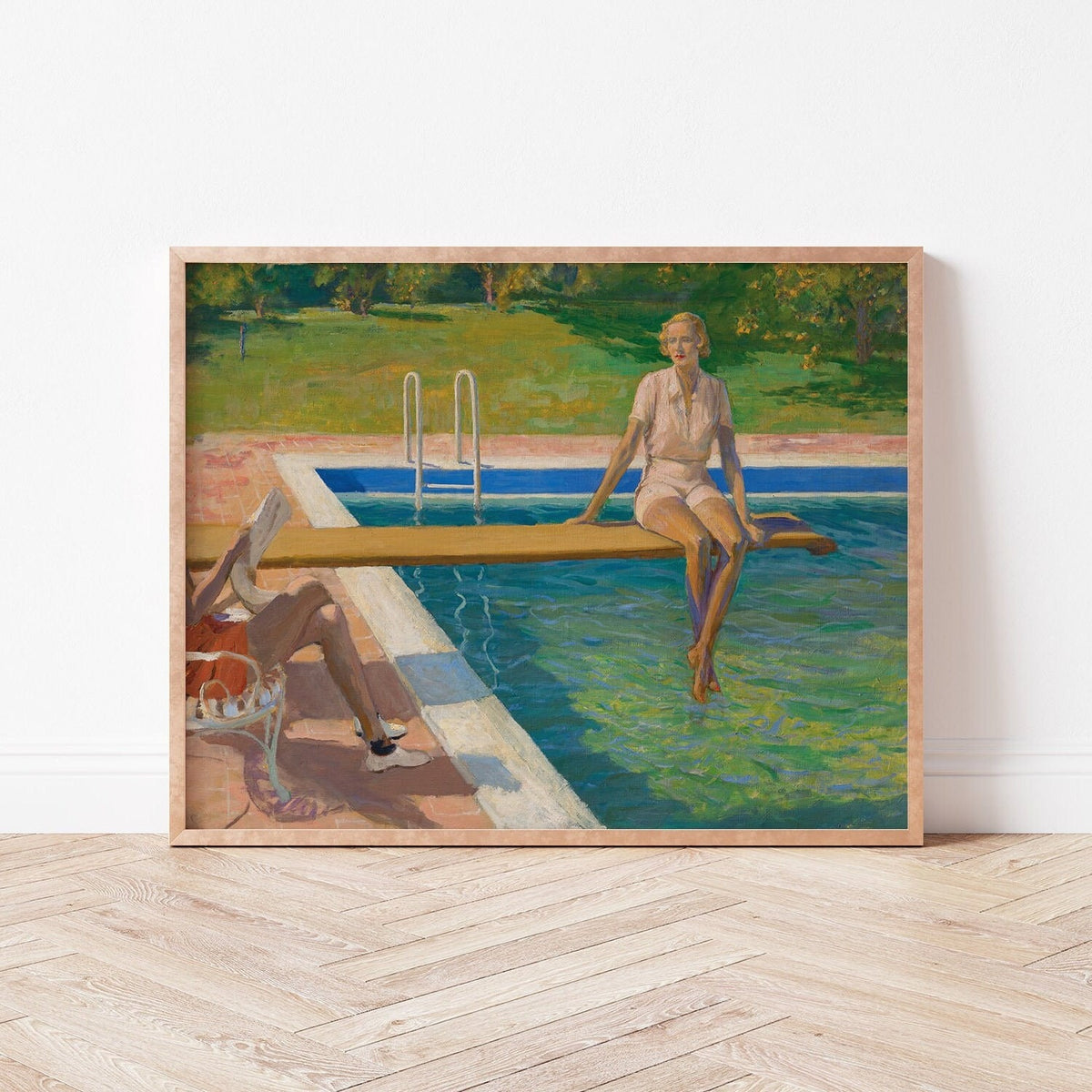 Framed print of a woman sitting by a pool with a man reading a newspaper.