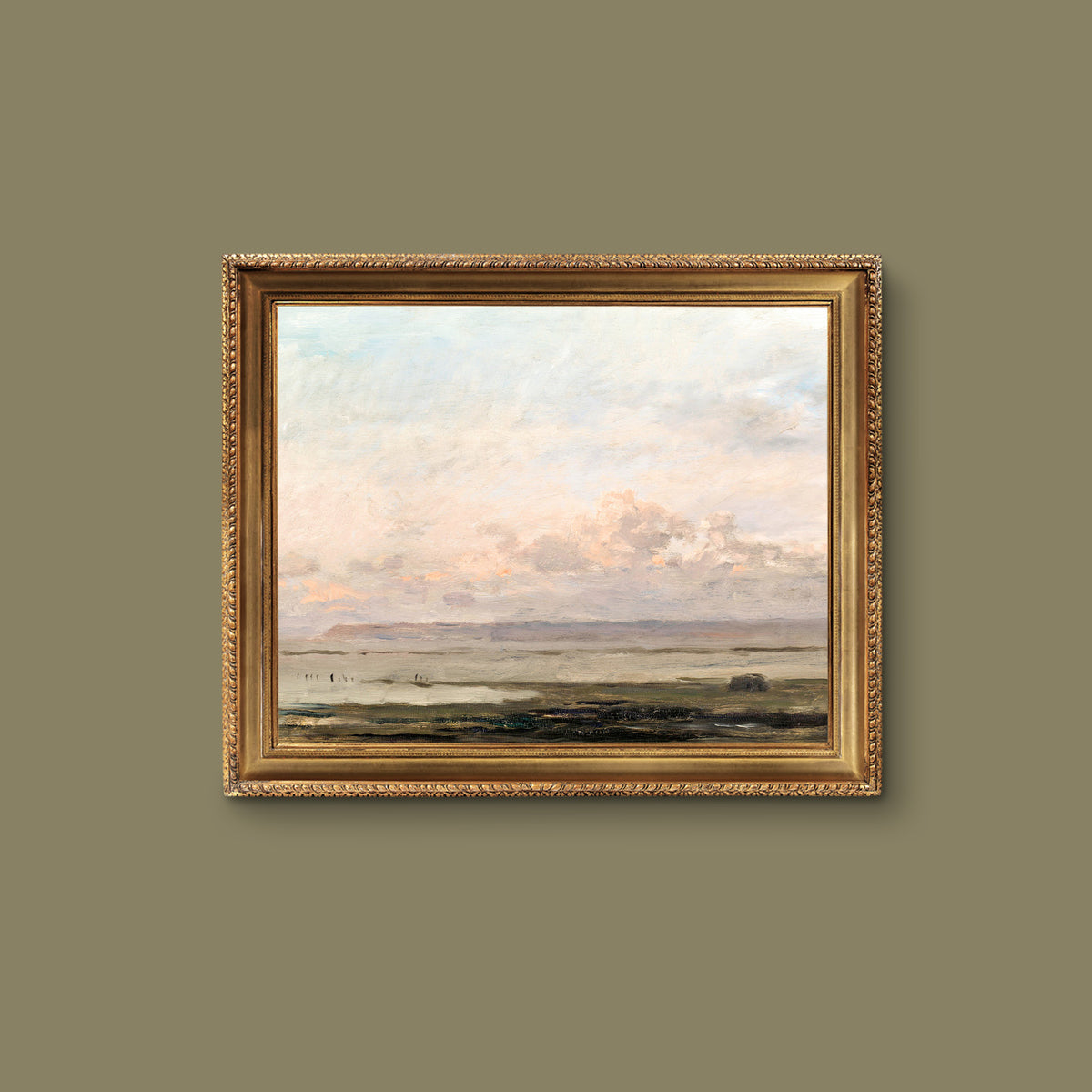 Framed print of a beach landscape on a gold frame on a green wall