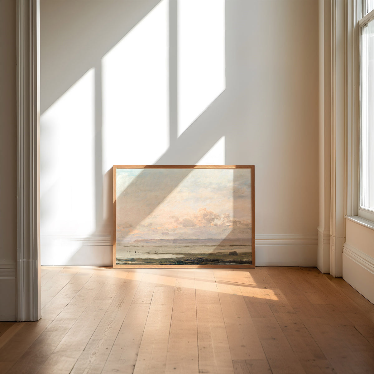 Framed artwork against a wall with sunlight casting shadows