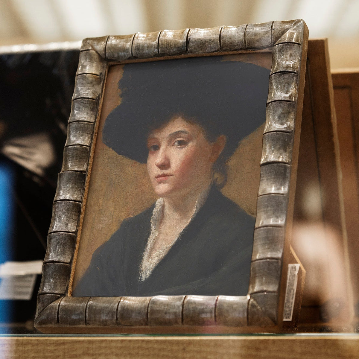 Small portrait in a decorative frame on a table