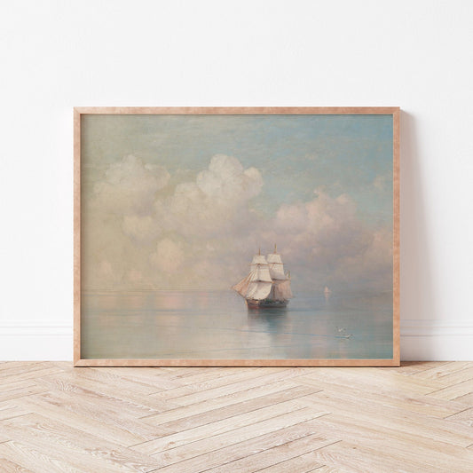 Framed artwork of a ship on water with clouds in a minimalistic room.