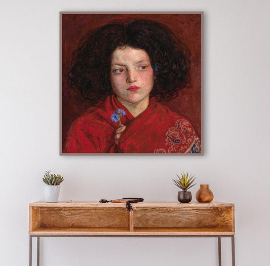 A fine art print of a beautiful oil painting of a young girl in a red shawl from mid 19th century. The artwork features rich red hues and beautiful brushwork. The print is displayed above a side table.