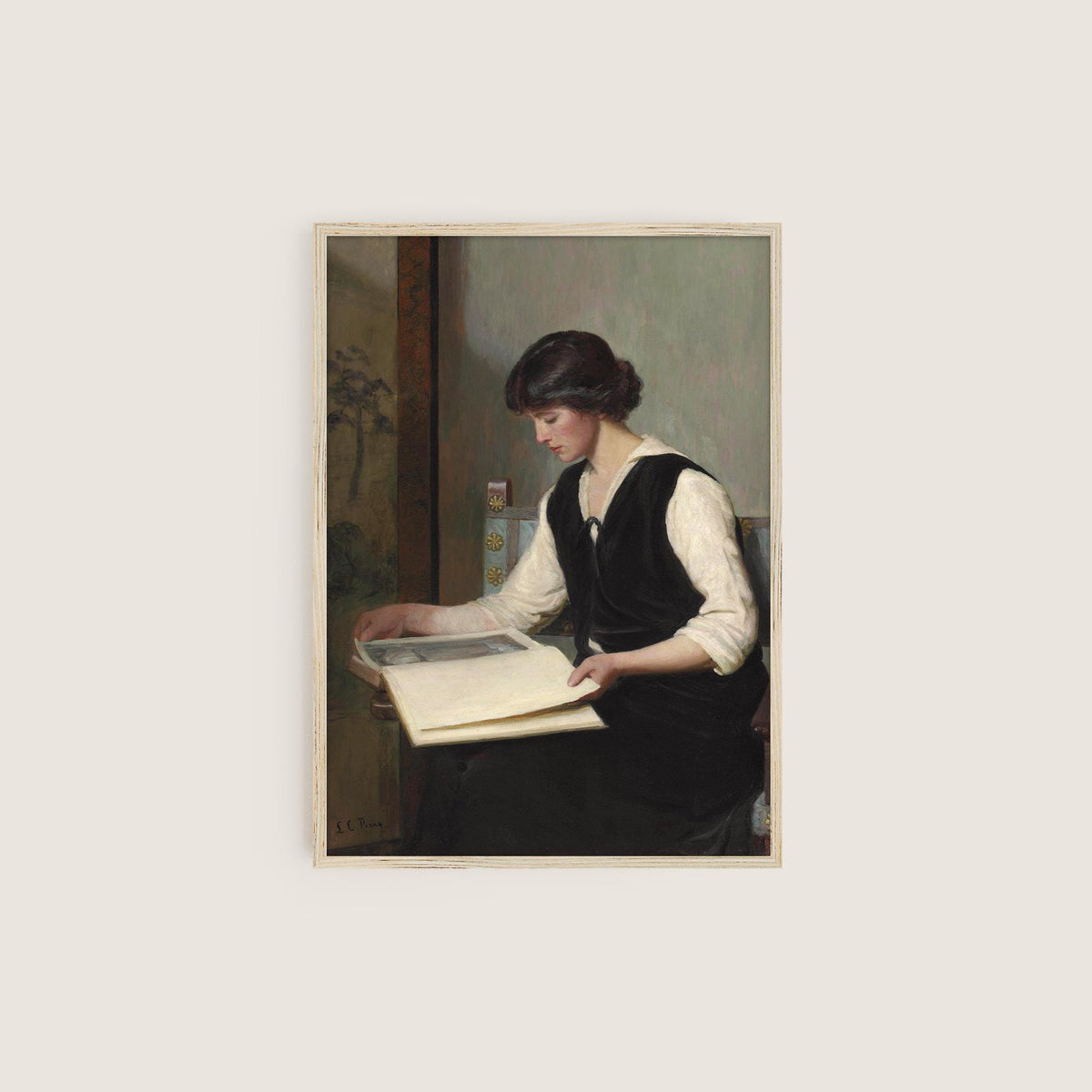 Framed print of a woman sitting with a book on a light gray background