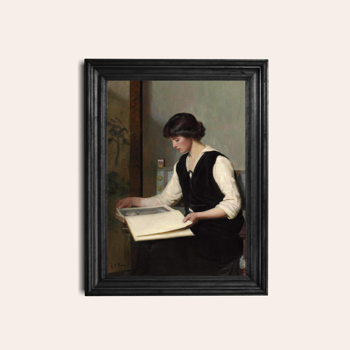 Framed print of a woman reading a book on a light beige background