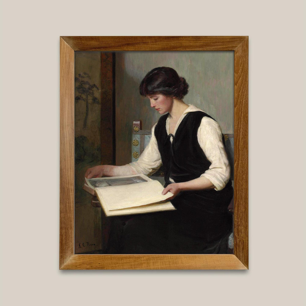Framed print of a woman reading a book.