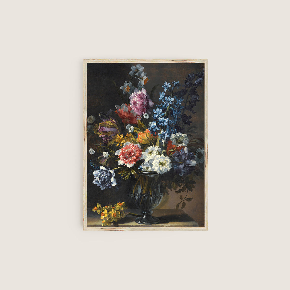 Framed floral print in a wooden frame on a white wall.