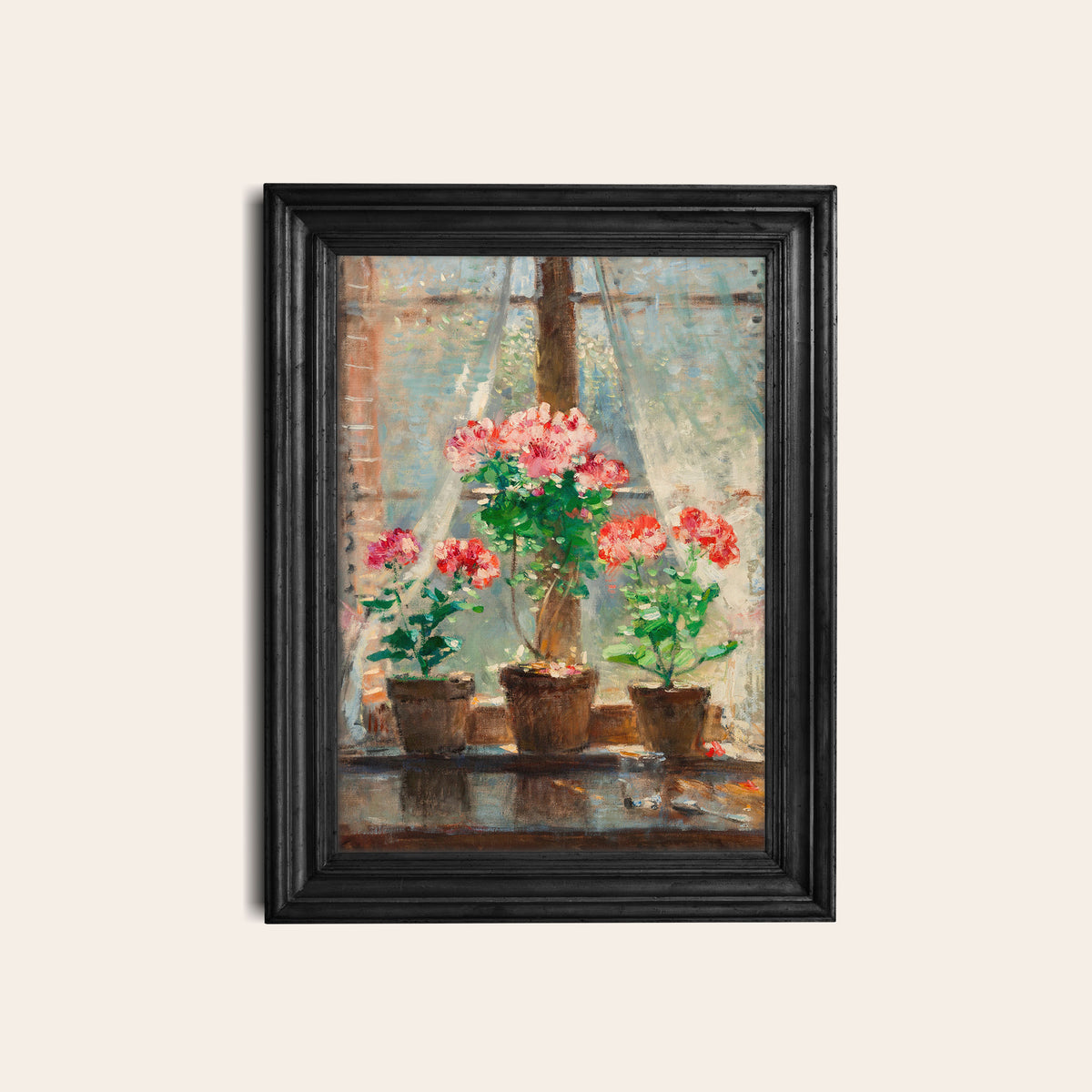 Framed print of potted flowers in front of a window, hung on a white wall in a black picture frame.