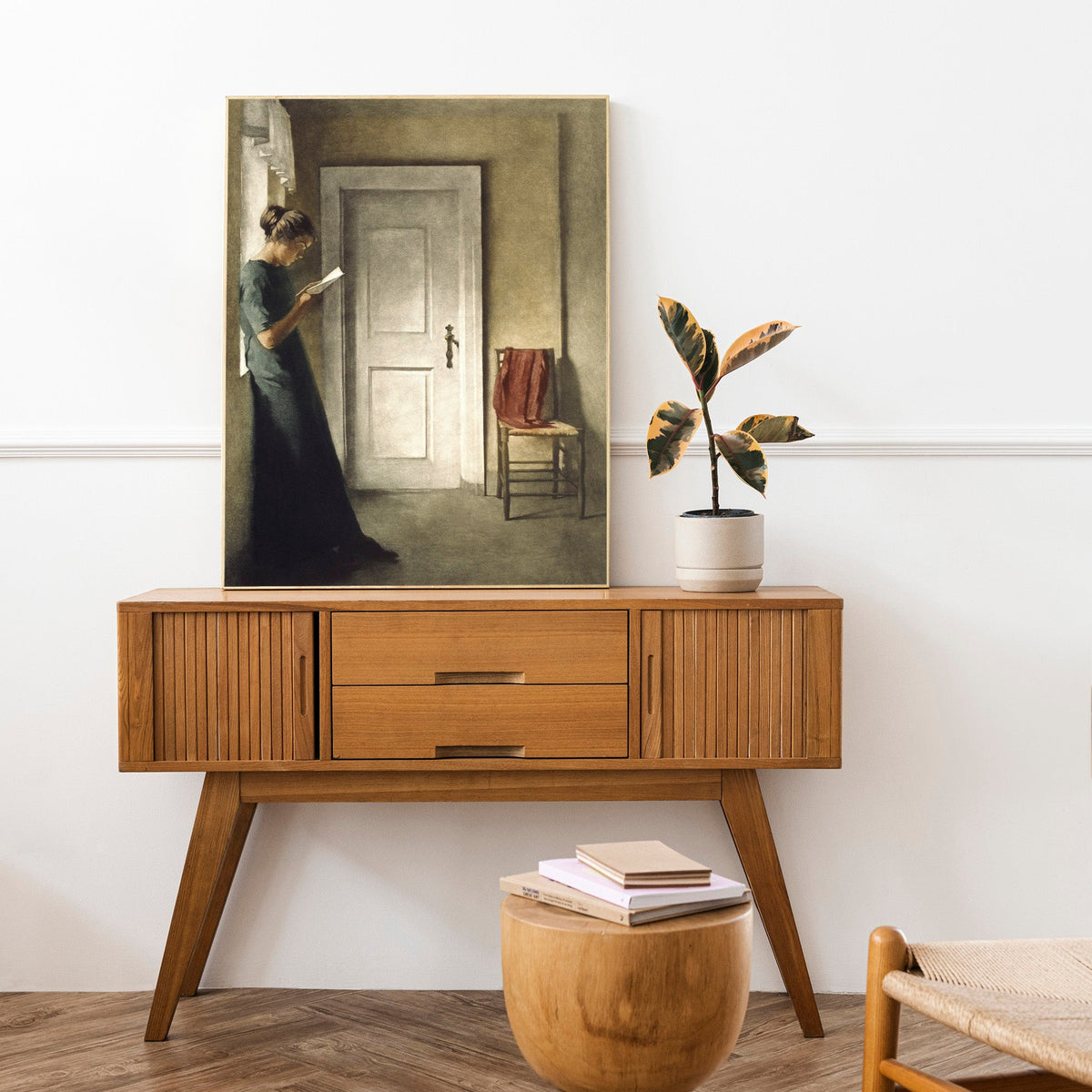 Wooden console table with mirror, stool, and chair in a room setting.