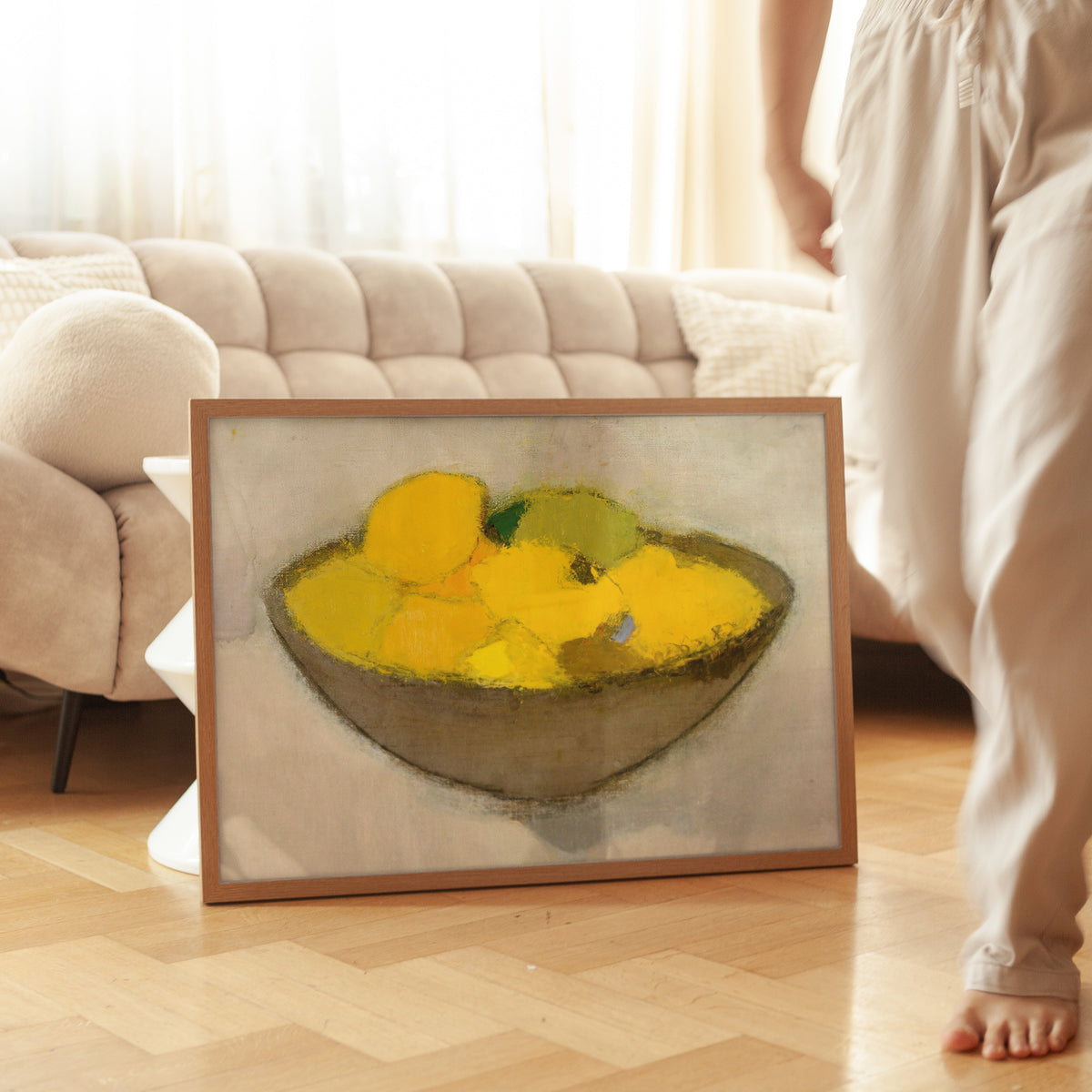 Framed artwork of a bowl of lemons on a neutral background.