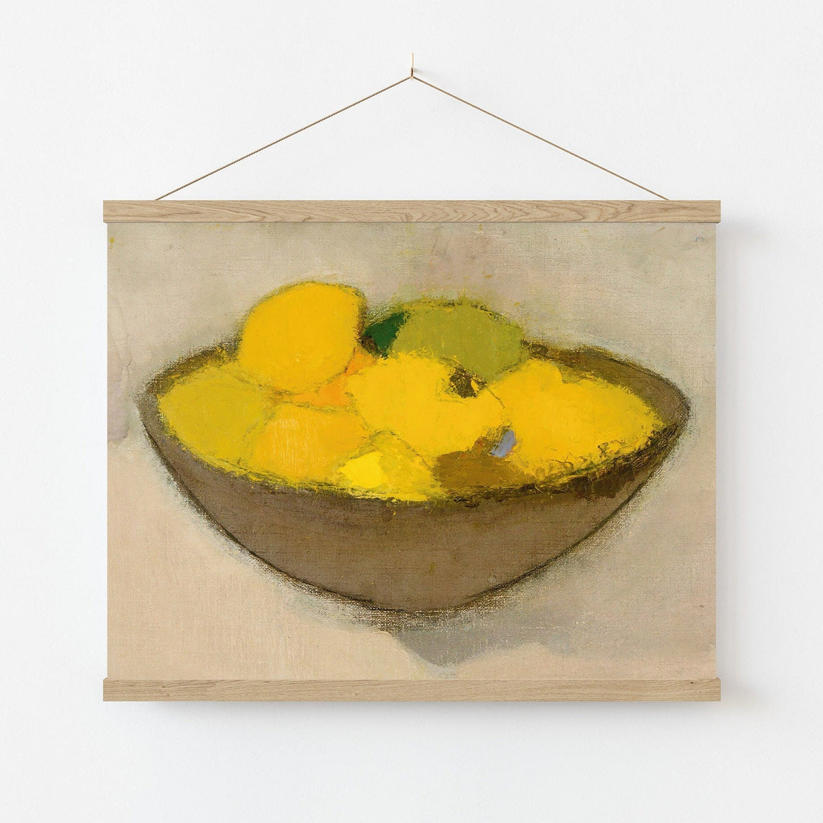 Print of a bowl of lemon on a beige background, hanging in a wooden poster hanger.