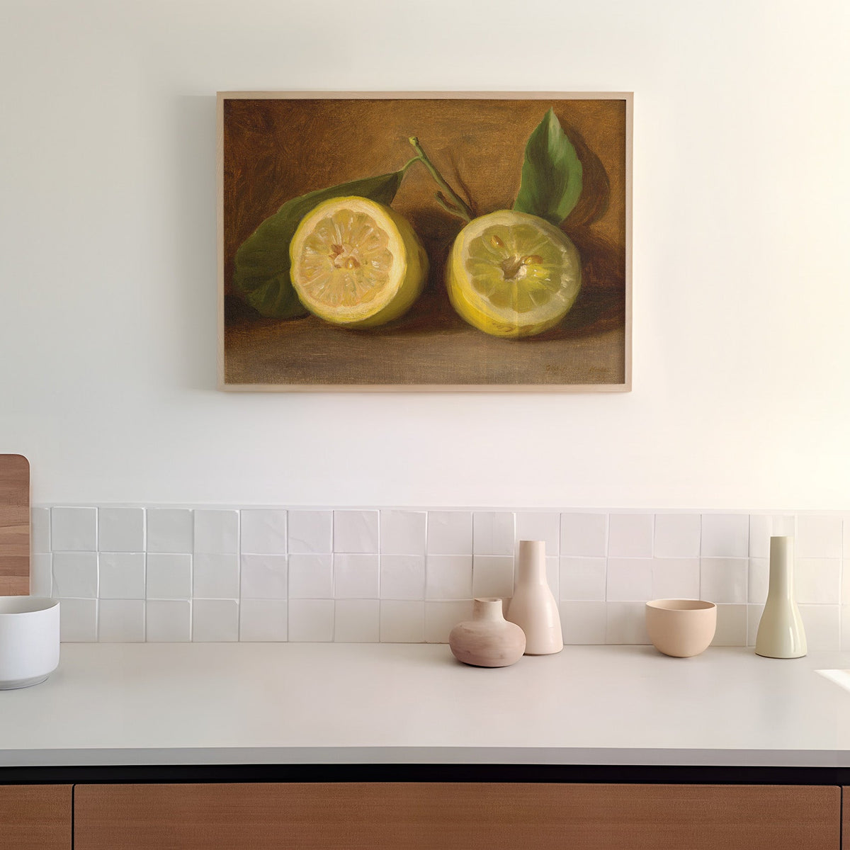Kitchen counter with decorative items and a print of lemons on the wall in a wooden picture frame.
