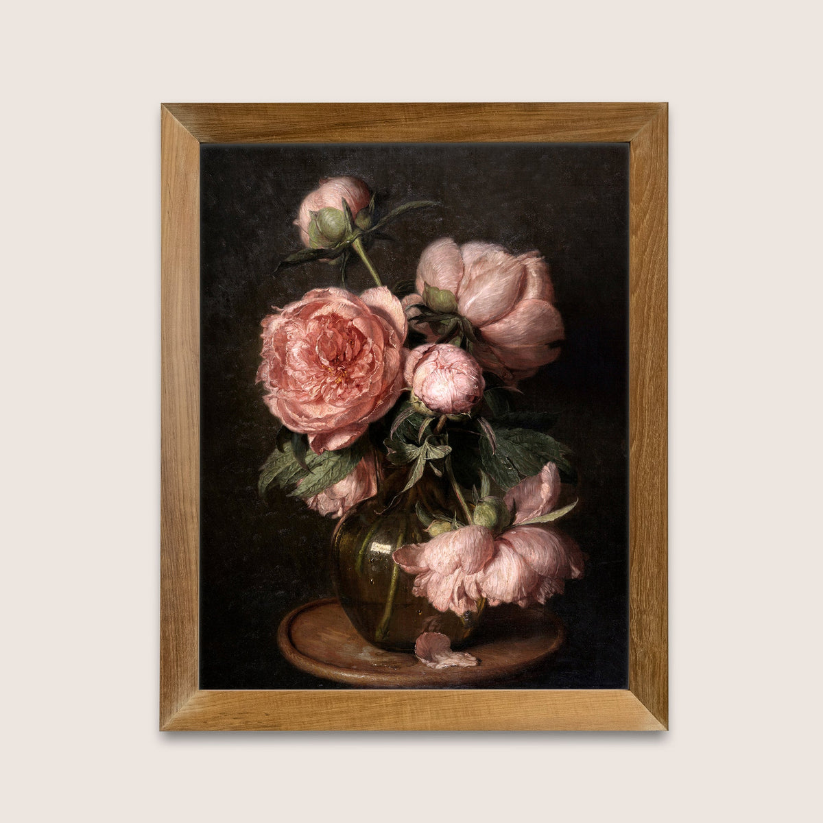 Framed art print of pink peonies on a dark background, hung on a white wall.