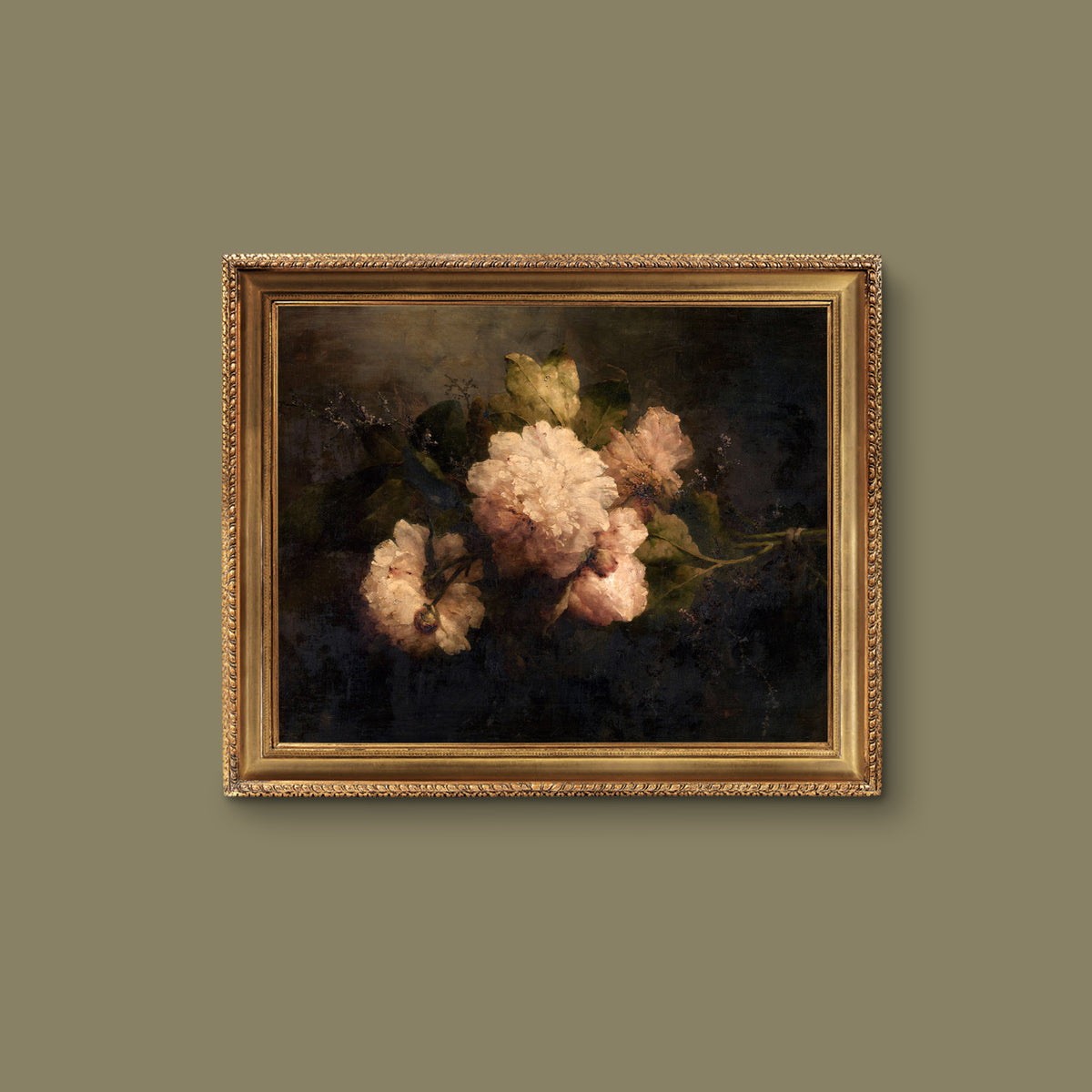 Framed print of flowers in a gold frame, hanging on a green wall