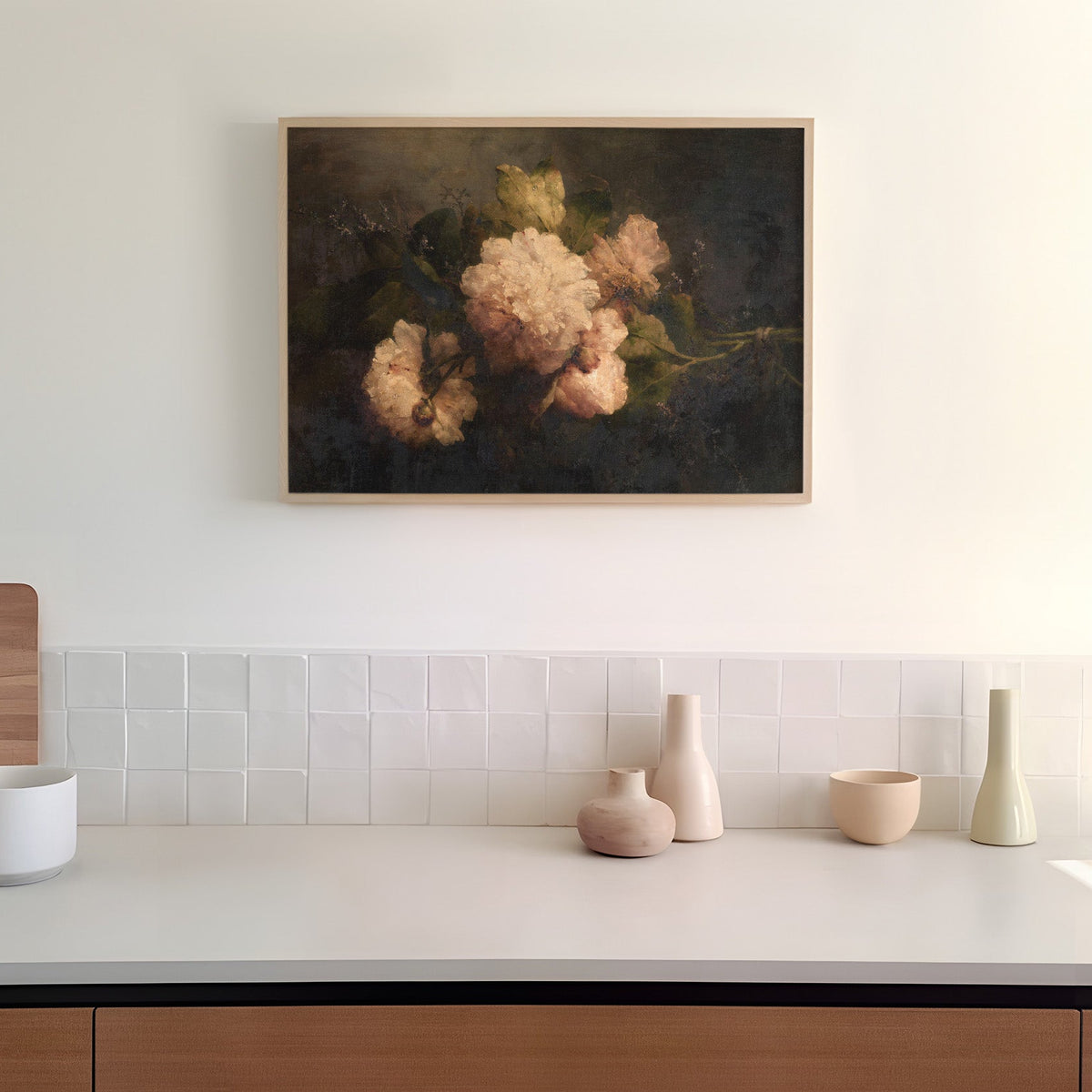 Kitchen counter with decorative vases and a floral painting on the wall.