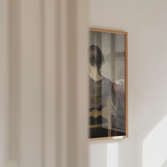 Video of a framed portrait of a female resting on a chair