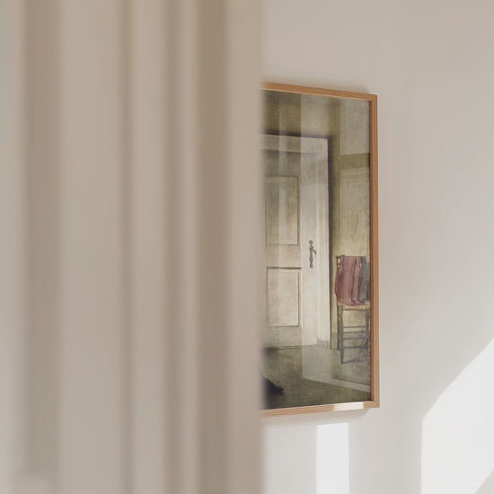 Video of a framed print of a lady reading panning across.