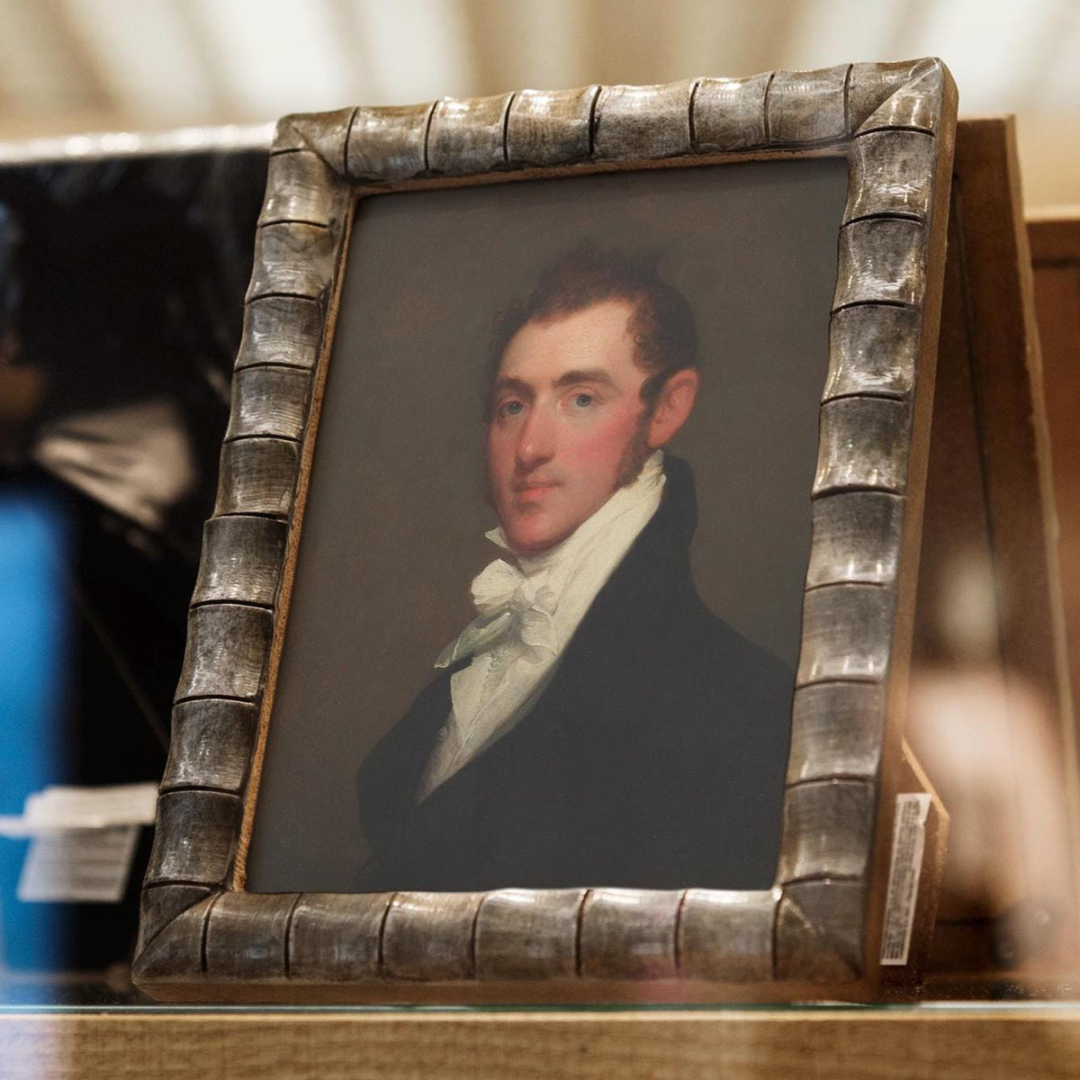 A fine art print of a Regency-era gentleman. The print is displayed in a gold bamboo effect picture frame.