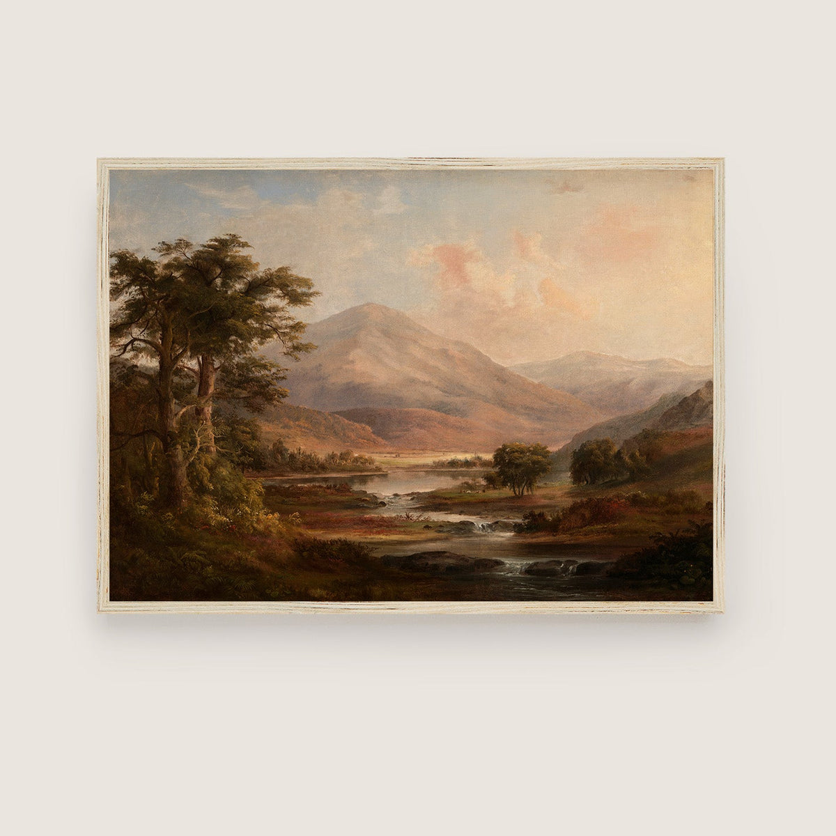Framed painting of a mountain landscape with a river on a white wall