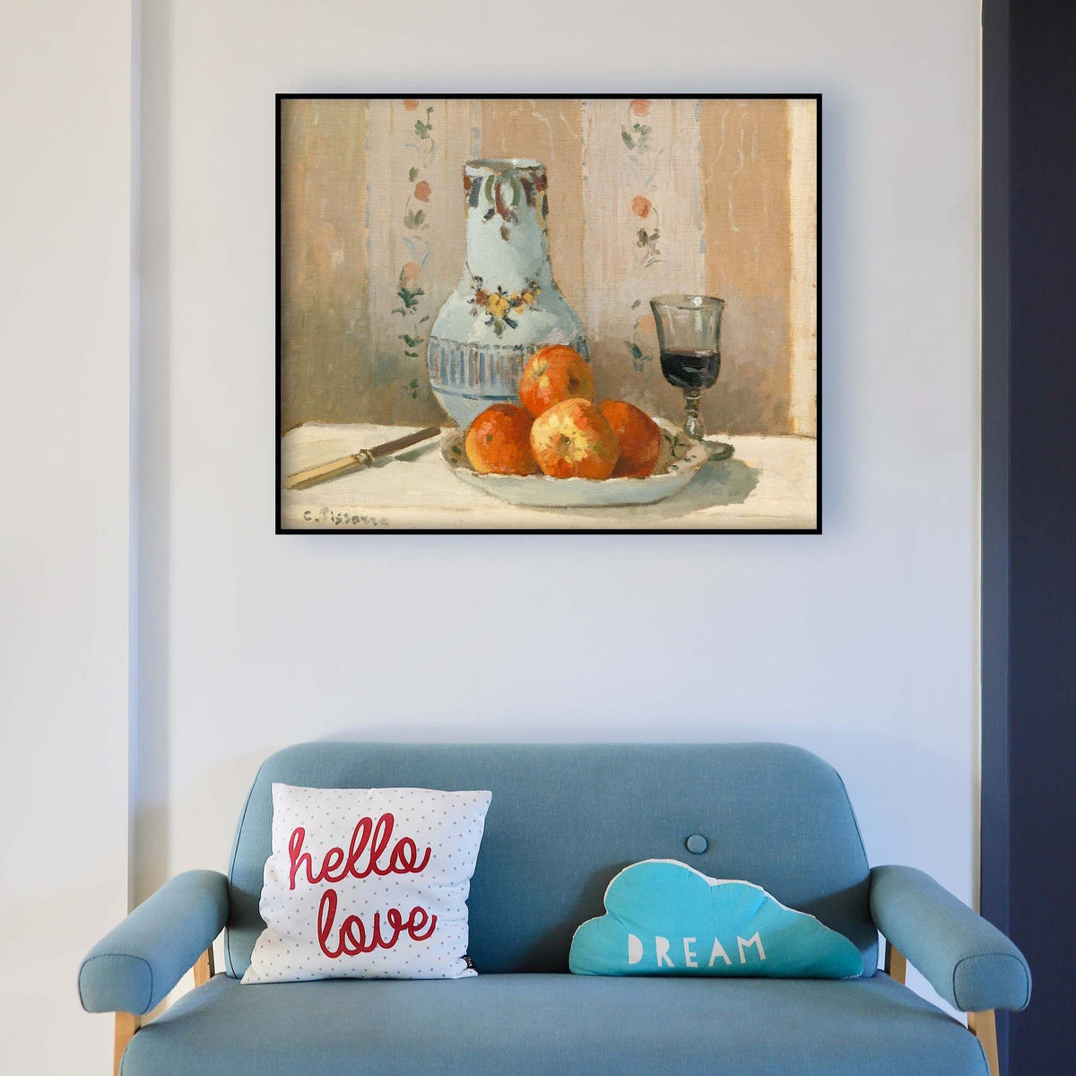A fine art print of a still-life oil painting. The print is displayed above a blue sofa.