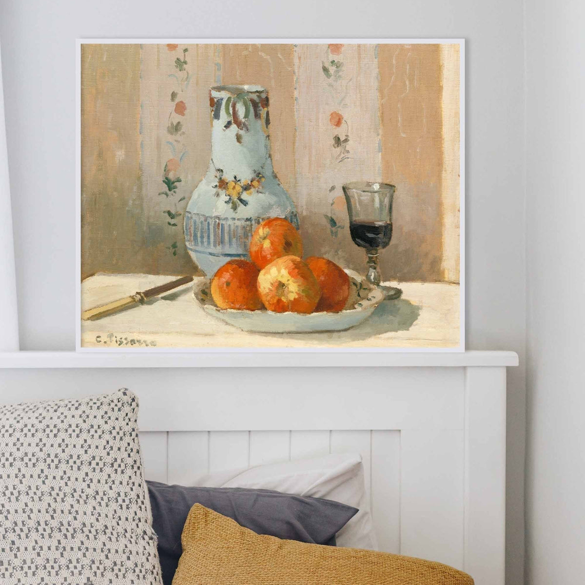 A fine art print of a still-life painting. The print is displayed on top of a headboard.